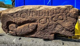 Archaeologist digs up 1,800-year-old slab near Hadrian's Wall carved with penis graffiti