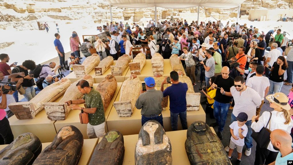 Painted coffins with well-preserved mummies inside, dating back to the Late Period of ancient Egypt around 500 B.C, and a trove of ancient artifacts recently unearthed, are displayed at a makeshift exhibit at the feet of the Step Pyramid of Djoser in Saqq