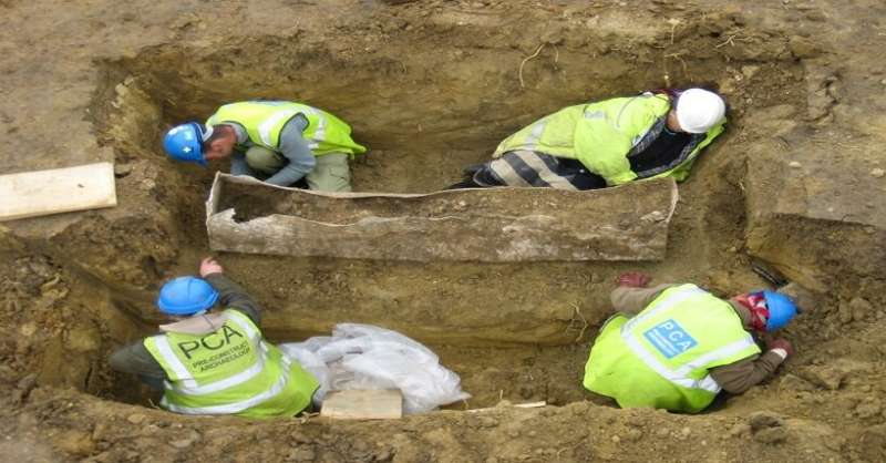 Archaeologists unearth the lead-lined coffin.